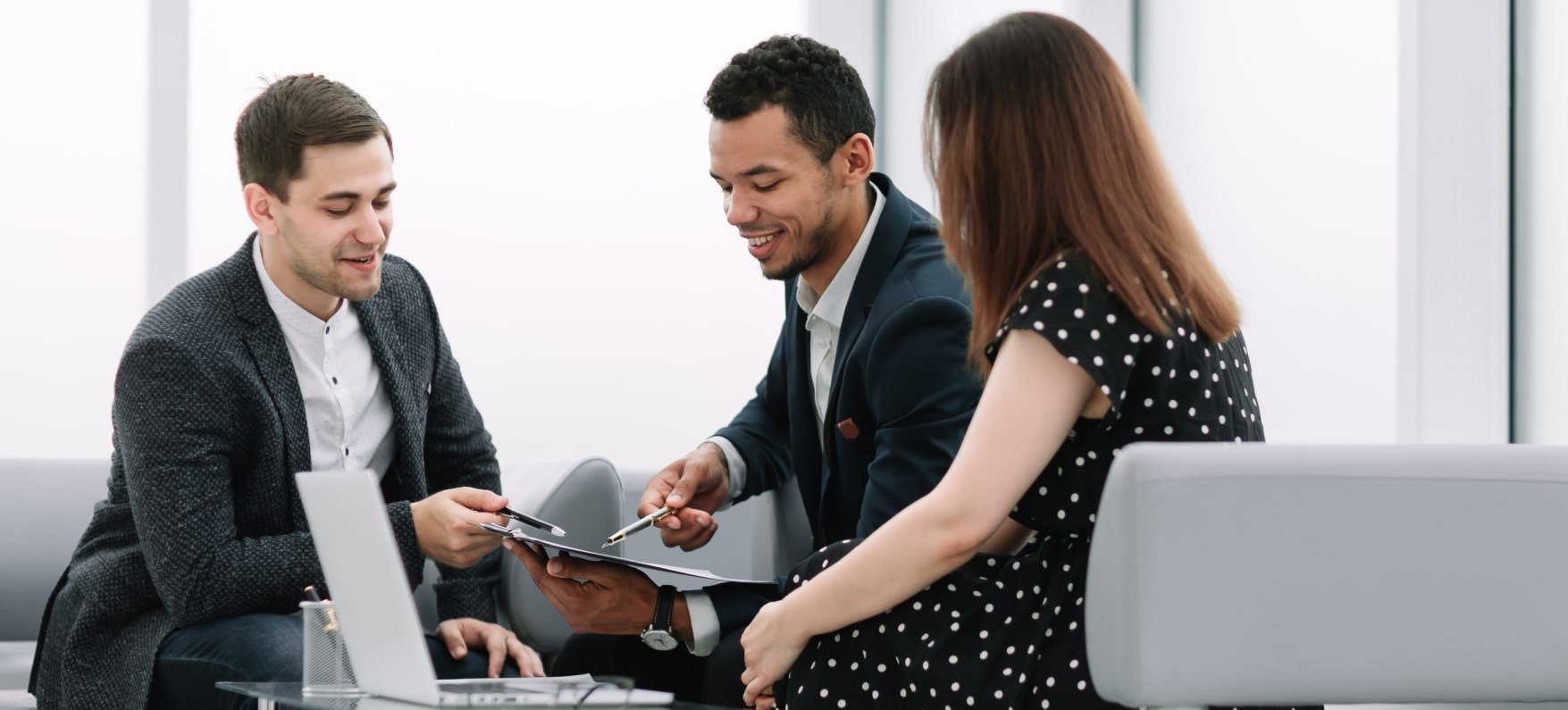 People Sitting Together Looking At The Document